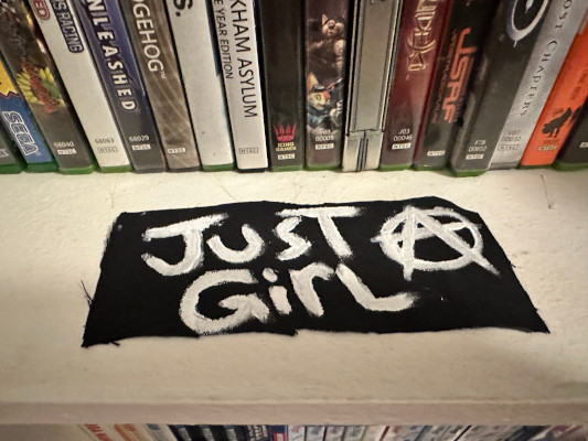 a patch that says Just a Girl and the A is the anarchy symbol
