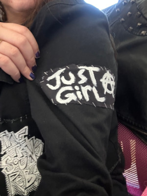 the Just a Girl patch on my right sleeve of my jacket