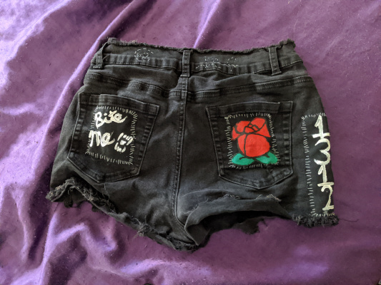 the back of my black shorts with a bite me patch on the left pocket with fangs, the rose patch on the right pocket and 1312 on the side of the shorts