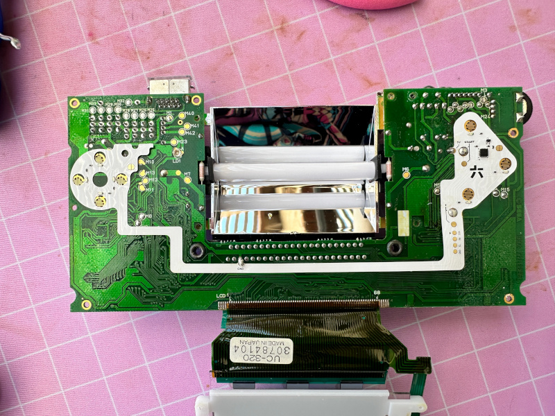 the game gear board with a LED strip soldered to it