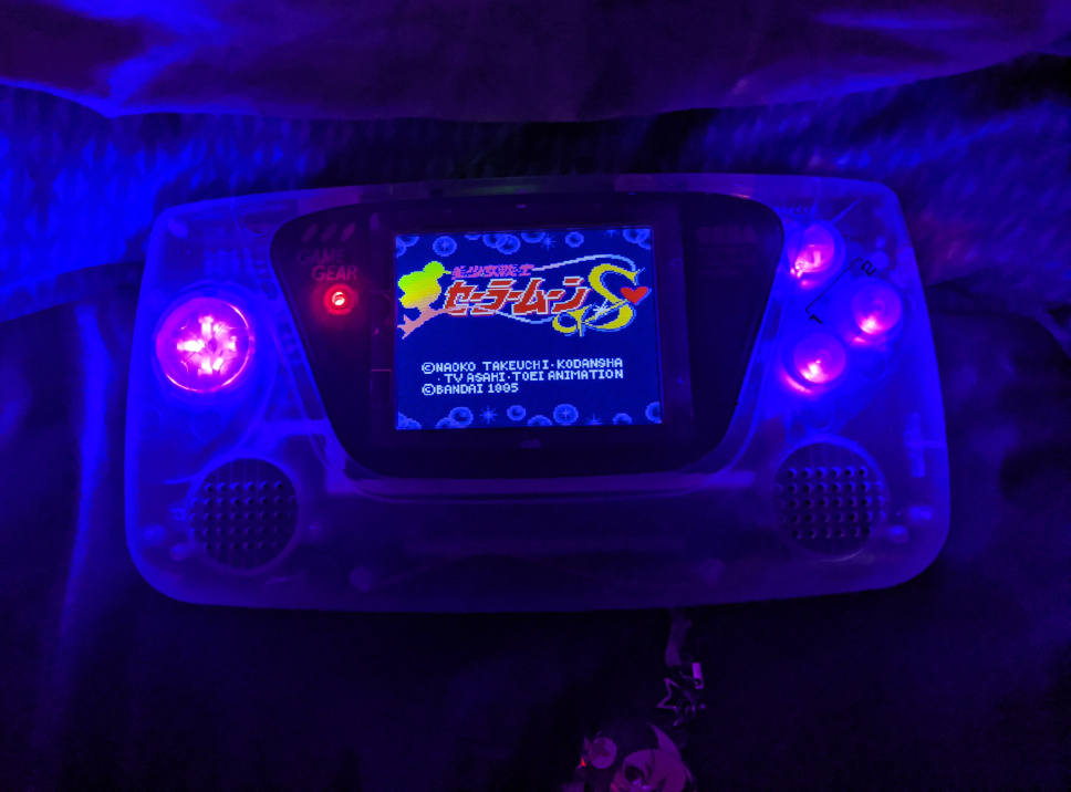 my clear sega game gear showing the new screen I installed with the open screen of the sailor moon game