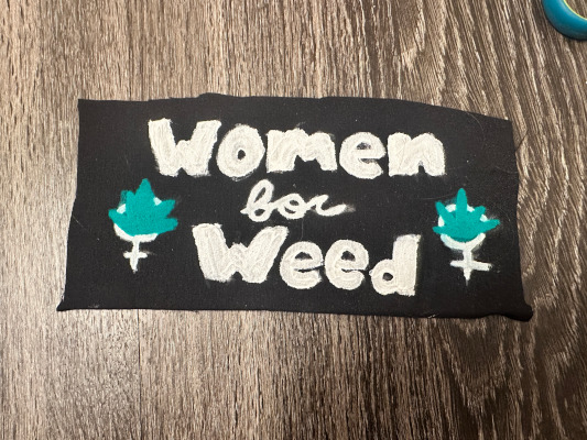 text saying women for weed between 2 female symbols with pot leaves in them