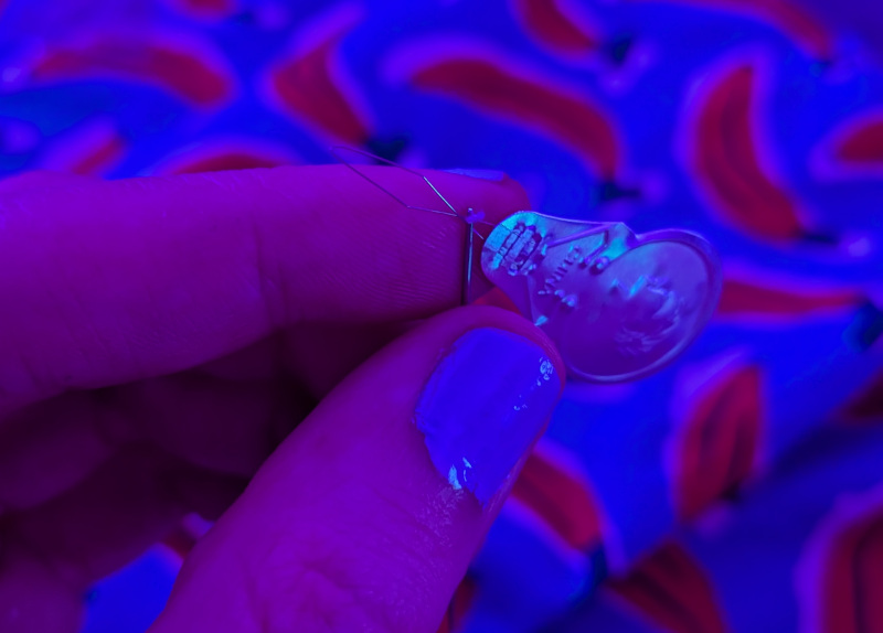 a needle with the threader thru the eye of it