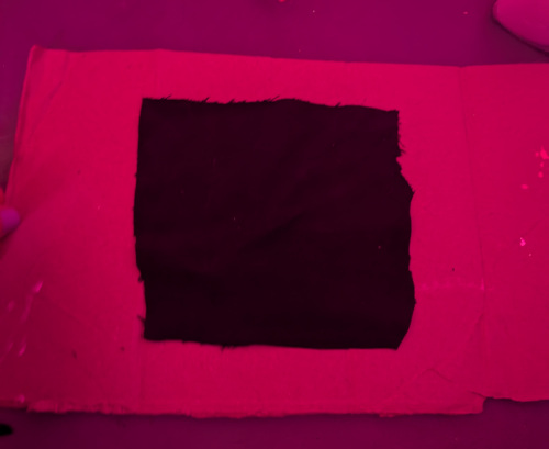 a square piece of black fabric on cardboard